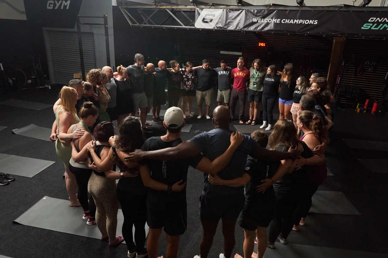 Participants in a closing circle at an Onnit gathering