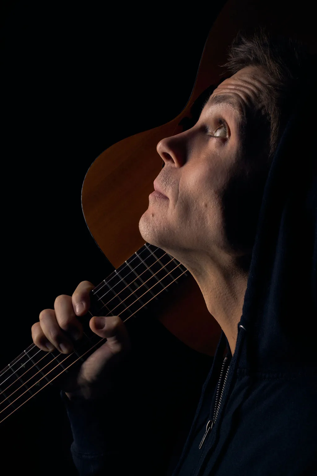 Seth holding an acoustic guitar