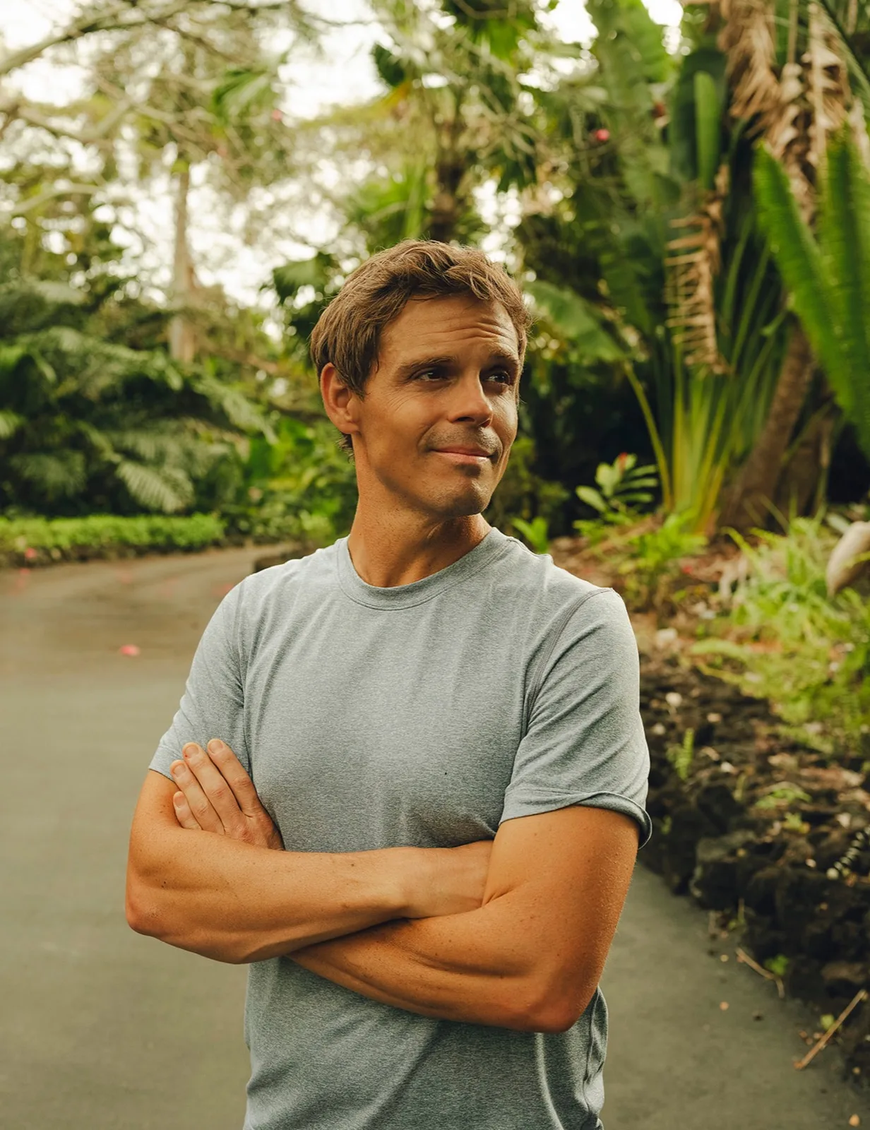 Seth Marcus standing in a tropical garden in Hawaiʻi